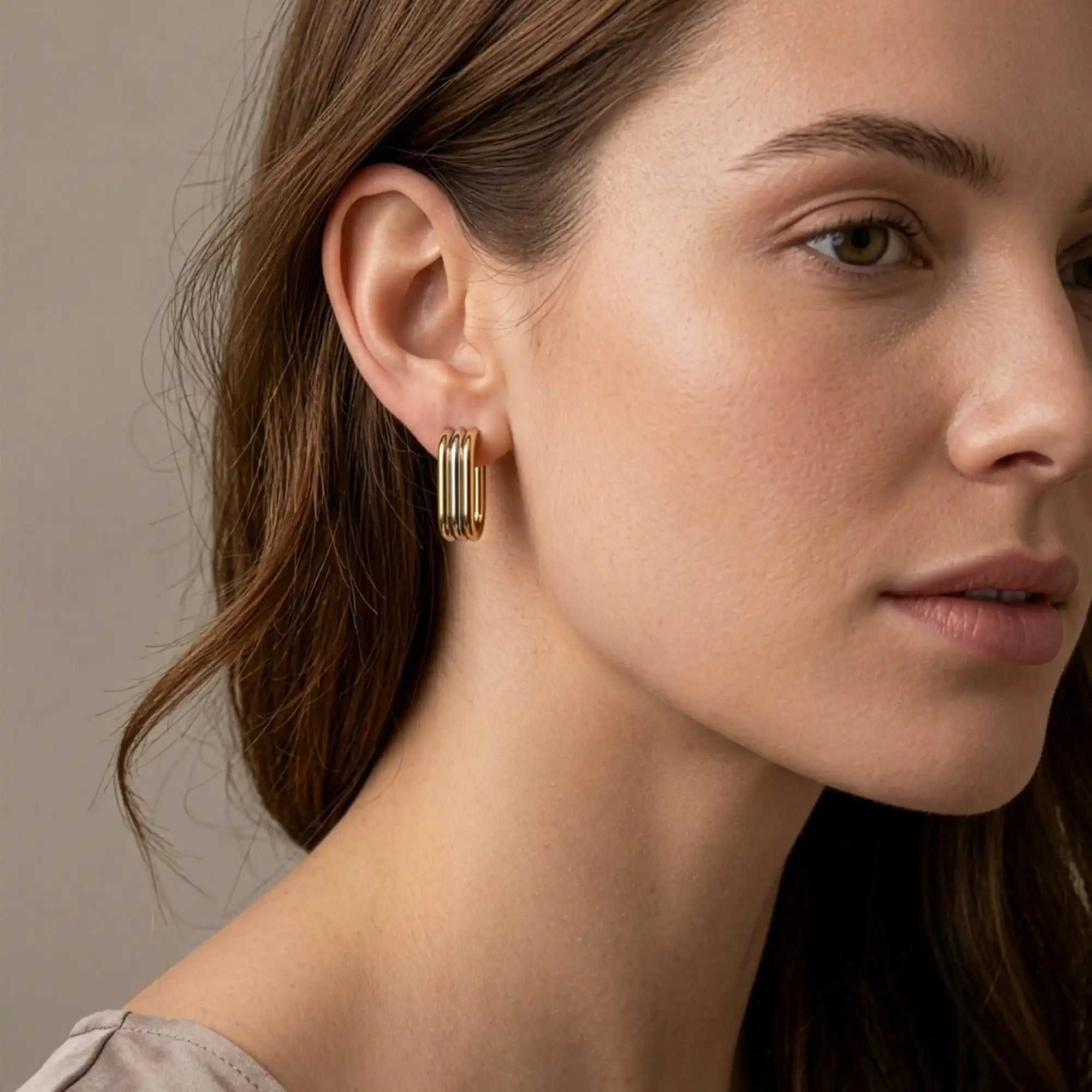 Nera Two-Tone Hoop Earrings gold silver on model ear — Tamola Jewellery