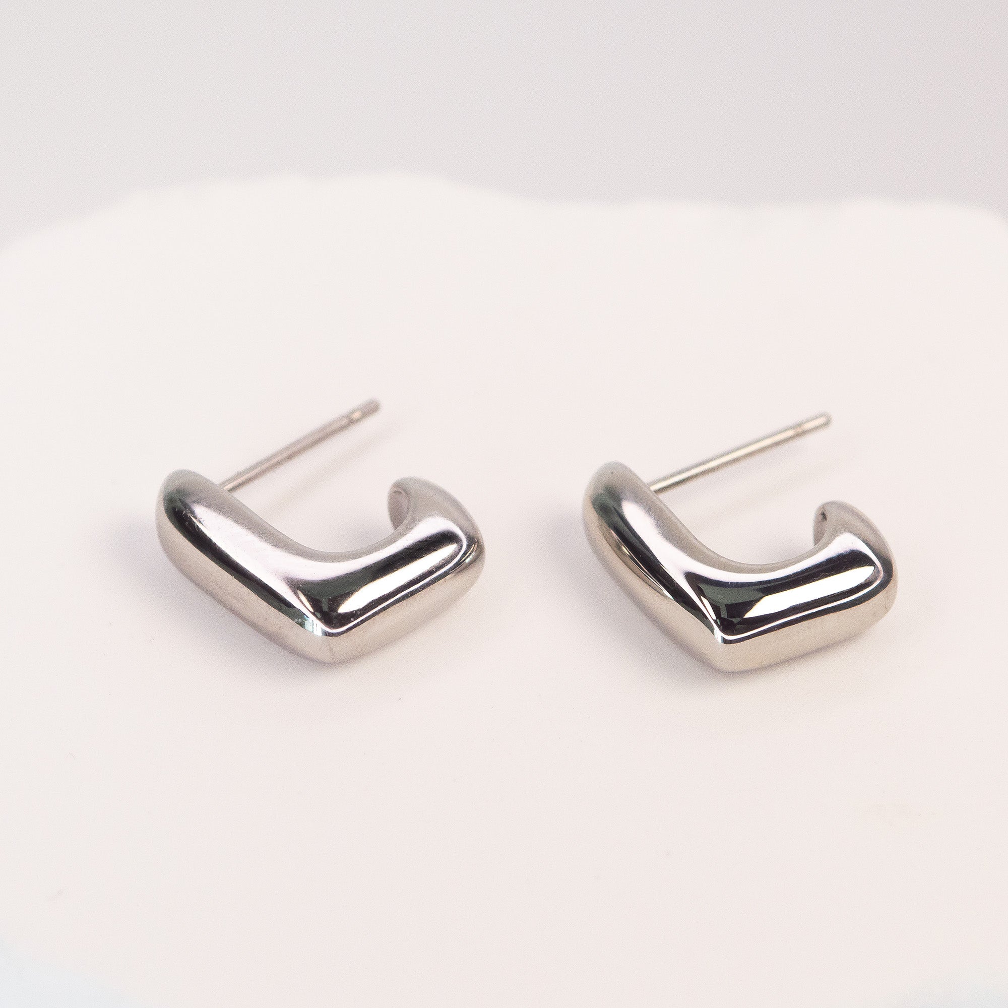 Solène Sculptural Huggie Earrings silver stainless steel — Tamola Jewellery